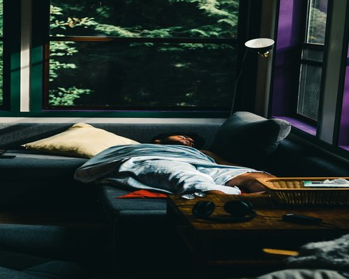 A person resting peacefully on a comfortable sofa during the weekend