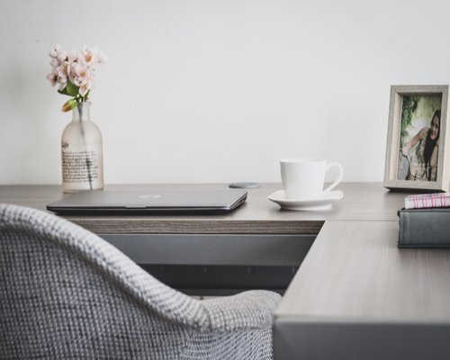 Person doing a light stretch at their home office desk
